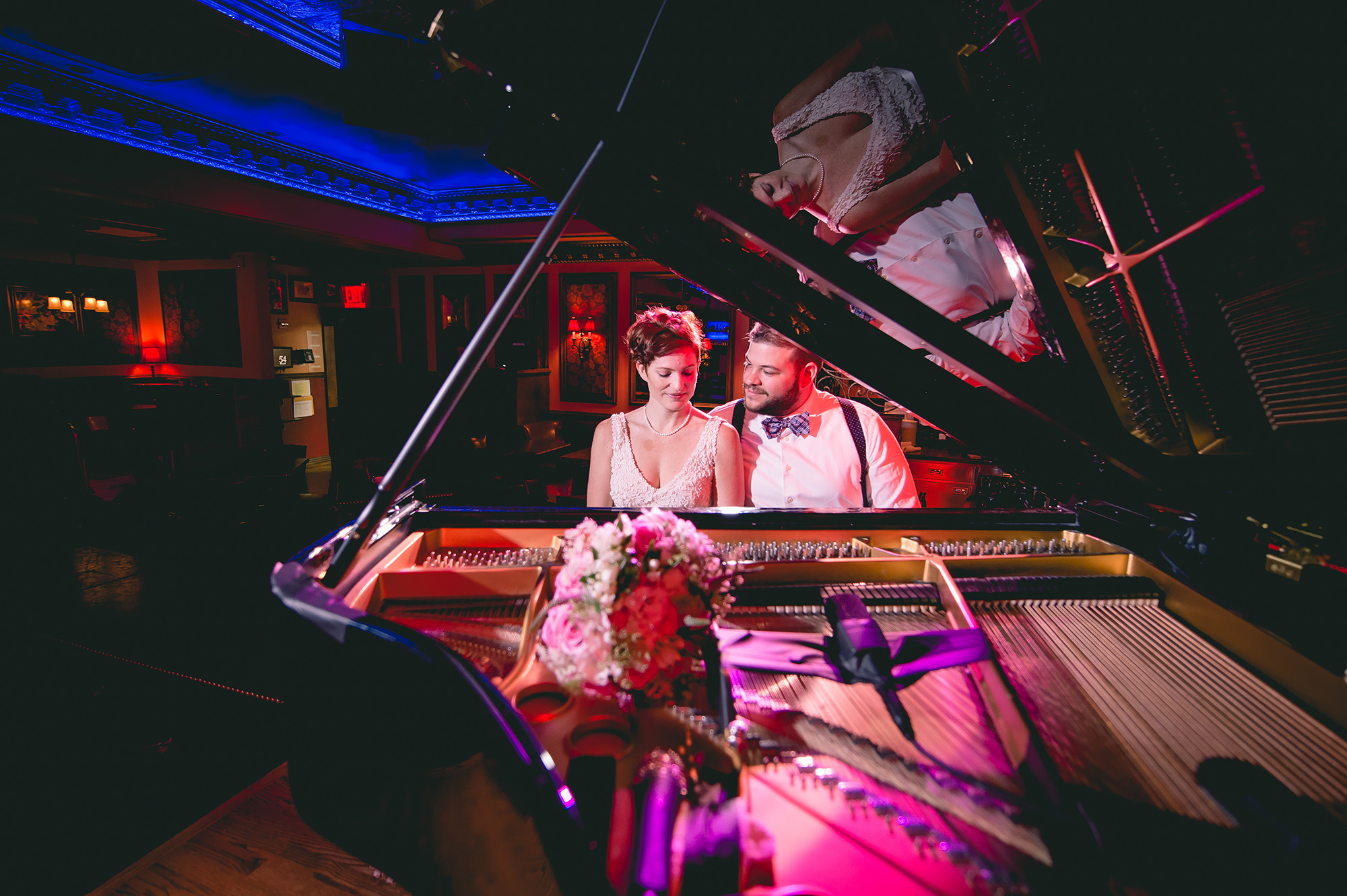 Bride and groom sitting at piano